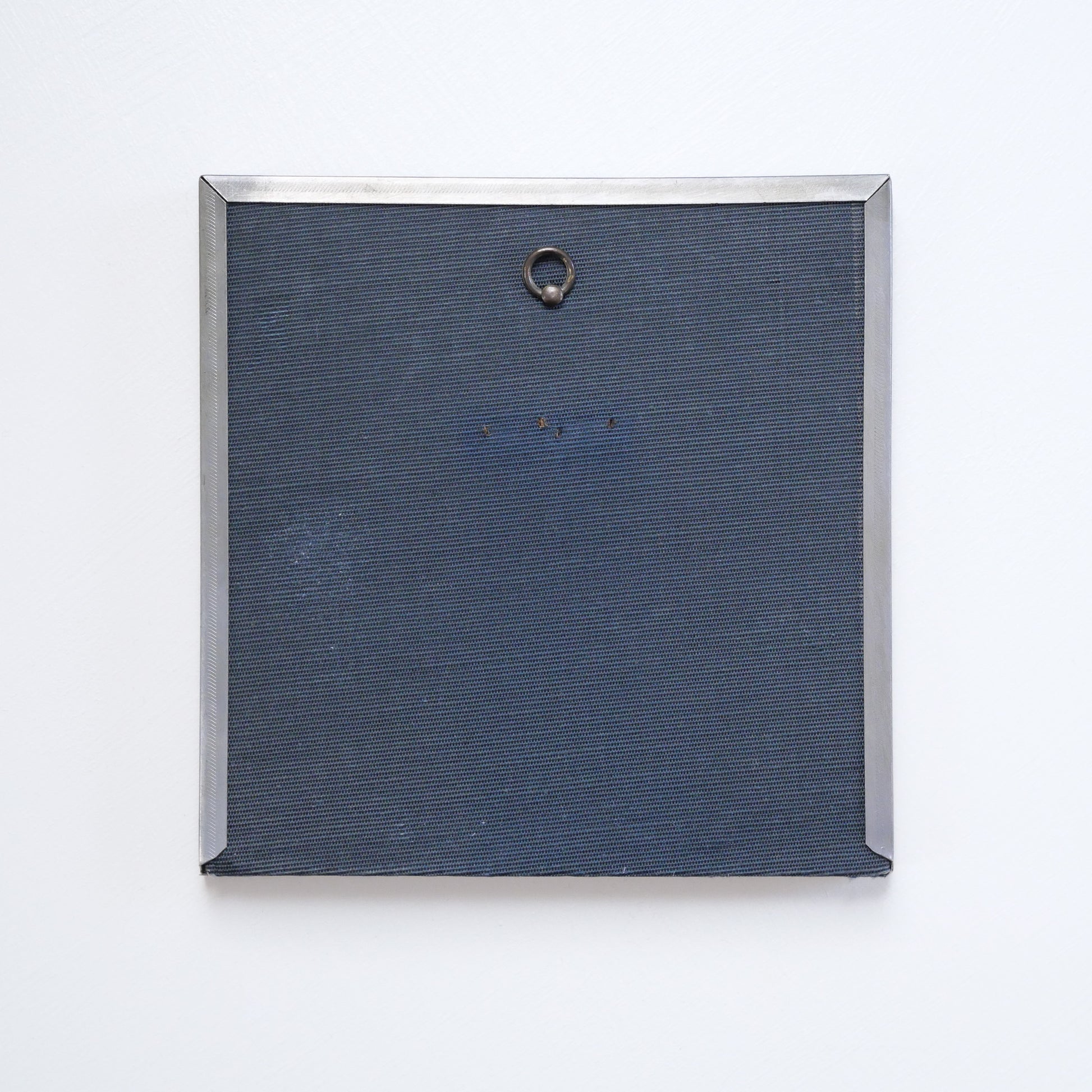 Back of recycled frame with small metal loop for hanging.